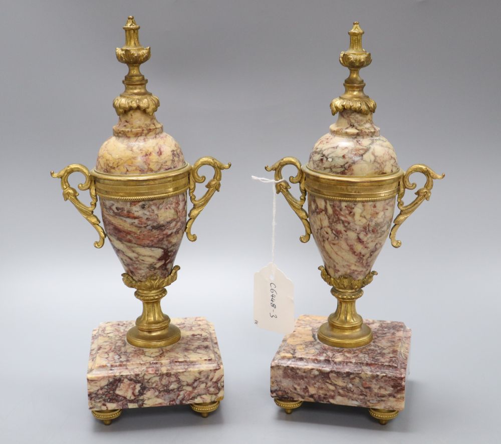 A pair of reconstituted marble and gilt metal urns, height 28.5cm